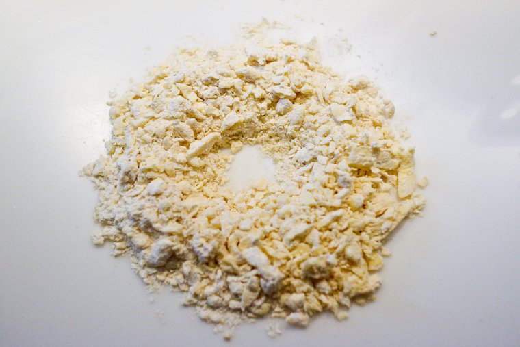 Cut the butter into the flour, turn out on a work surface, and form a well in the center.