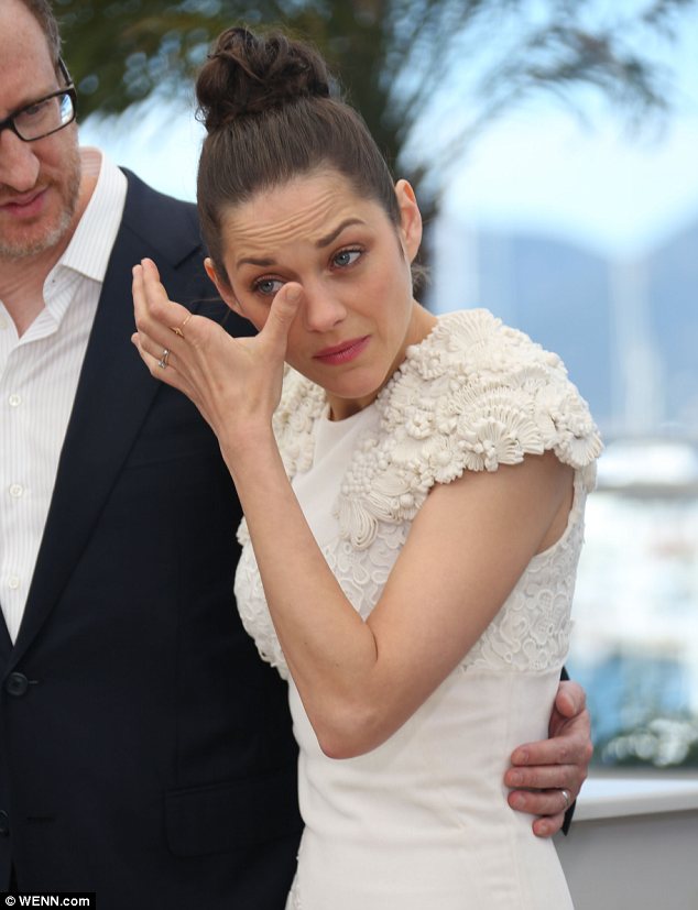 Why so sad? Marion Cottilard was seen wiping away tears as she posed for pictures at The Immigrant photo call in Cannes