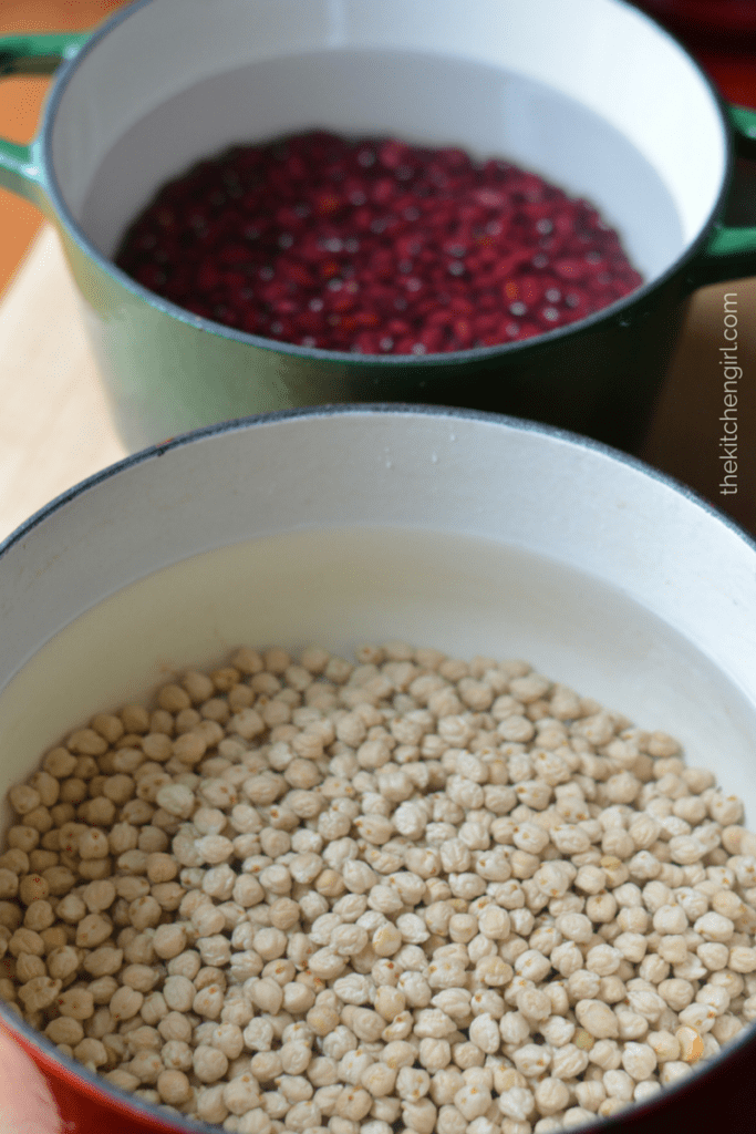 dried beans in dutch ovens filled with water