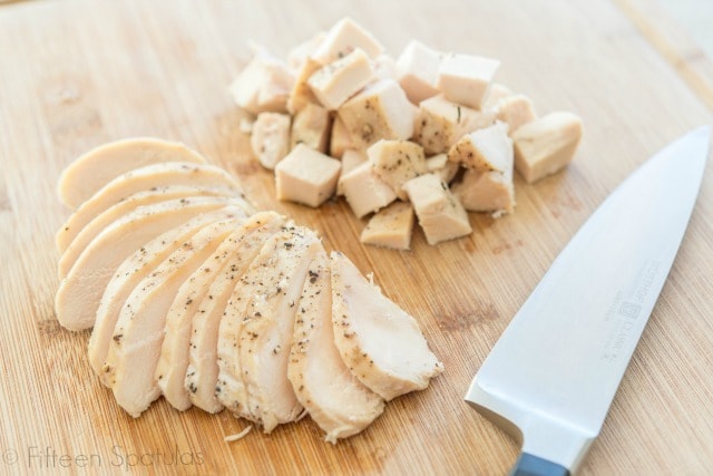 Crockpot Chicken Breast - Shown Sliced and Cubed for tacos, rice, salads, and more on a cutting board
